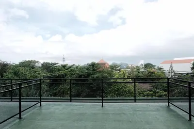 a balcony with a view of the city at TropicalLoft With Ocean View From Rooftop -RARE! in Canggu