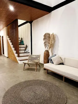 a living room with a white couch and a rug at TropicalLoft With Ocean View From Rooftop -RARE! in Canggu