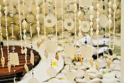 a wall of beads with the word love on it at Villa Domus De Janas in Seminyak