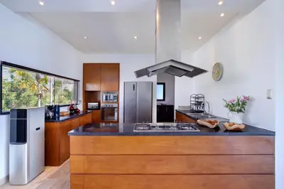 a kitchen with a counter top with a stove top oven at The Lookout Villa Jimbaran By Island Escape in Jimbaran