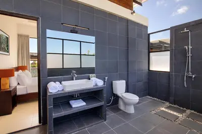 a bathroom with a sink and a toilet at The Lookout Villa Jimbaran By Island Escape in Jimbaran