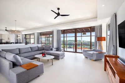 a living room with a couch and a table at The Lookout Villa Jimbaran By Island Escape in Jimbaran