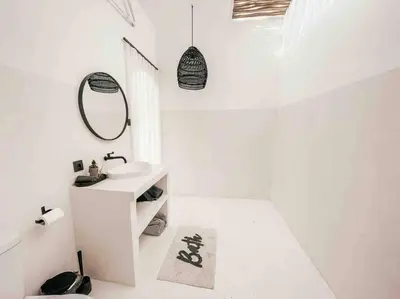 a white bathroom with a sink and a mirror at Renovated 2BD Oasis with POOL - CasaEra in Seminyak main hub in Seminyak