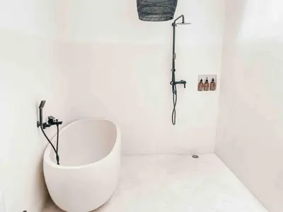 a white bathroom with a shower and a tub at Renovated 2BD Oasis with POOL - CasaEra in Seminyak main hub in Seminyak
