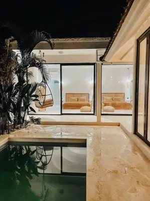 a room with a table and some chairs in a room at Renovated 2BD Oasis with POOL - CasaEra in Seminyak main hub in Seminyak
