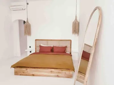 a bed with red pillows and a ladder in a room at Renovated 2BD Oasis with POOL - CasaEra in Seminyak main hub in Seminyak