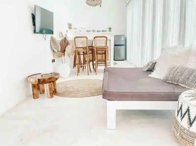 a living room with a bed and a table and chairs at Renovated 2BD Oasis with POOL - CasaEra in Seminyak main hub in Seminyak