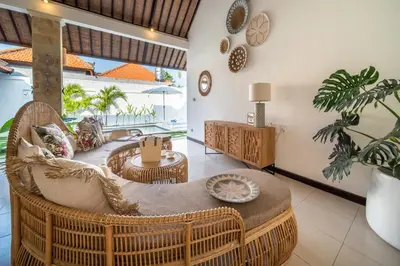 a living room with a rattan chair and tables at 2 bedroom Balinese private pool villa in Seminyak in Seminyak