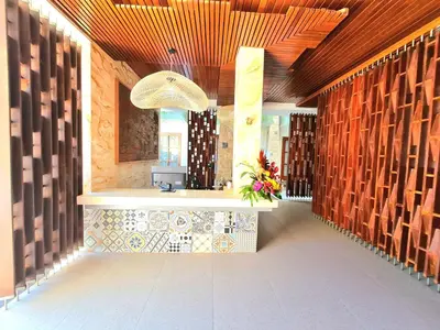 a lobby of a building with wooden walls at Kamandaka in Kuta