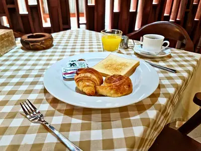 a plate of pastries and bread on a table at Kamandaka in Kuta