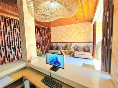 a computer sitting on a desk in a room at Kamandaka in Kuta