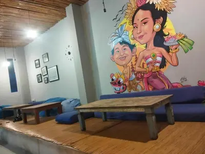 a room with a table and a mural on the wall at The Island Bali in Seminyak