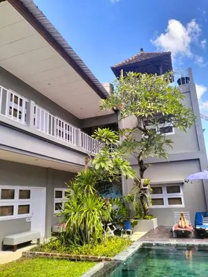 a house with a swimming pool in front of it at The Island Bali in Seminyak