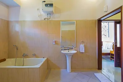 a bathroom with a tub and a sink and a bath tub at Kubal Villa and Living Seminyak in Canggu