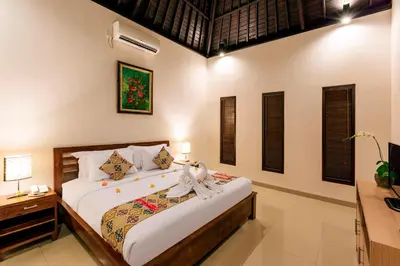 a bedroom with a large bed in a room at Kubal Villa and Living Seminyak in Canggu