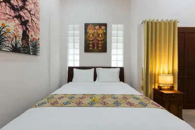 a bedroom with a bed and a window at Kubal Villa and Living Seminyak in Canggu