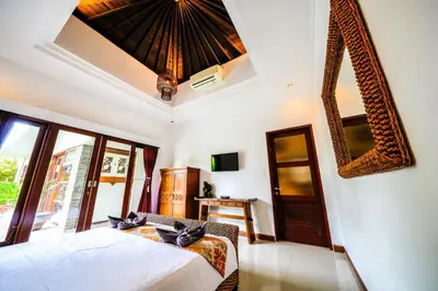 a bedroom with a bed and a ceiling at Villa VINO - LEGIAN - 3 bedroom - 3 bathroom Villa - Great Location in Seminyak
