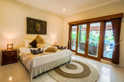a bedroom with a bed and a large window at Villa CONOR - LEGIAN - SEMINYAK - 2 Bedroom 2 Bathroom Villa - Great Location in Seminyak