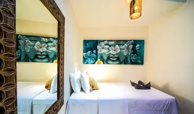 two beds in a room with a mirror at Villa CONOR - LEGIAN - SEMINYAK - 2 Bedroom 2 Bathroom Villa - Great Location in Seminyak