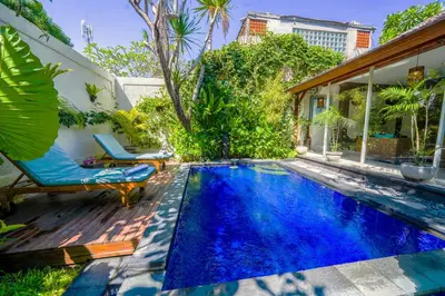 a swimming pool with blue water in a backyard at Villa CONOR - LEGIAN - SEMINYAK - 2 Bedroom 2 Bathroom Villa - Great Location in Seminyak