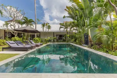 a swimming pool in front of a villa at Villa Budha 1: 4bedrs 12m Pool, 700m2 garden with BBQ in Seminyak