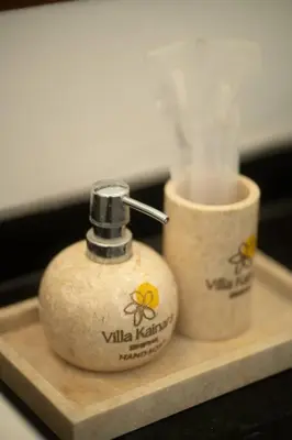 two soap dispensers sitting on a wooden shelf at Villa Kainara 2 - Cozy villa in center of Seminyak in Seminyak