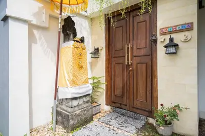 a door to a house with a dress on it at Villa Kainara 2 - Cozy villa in center of Seminyak in Seminyak