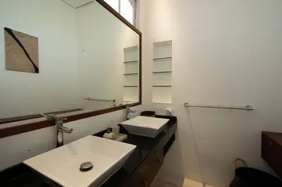 a white bathroom with a sink and a mirror at Villa Kainara 2 - Cozy villa in center of Seminyak in Seminyak