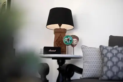 a lamp sitting on a table next to a couch at Martini Beachside Villa 1 in Canggu