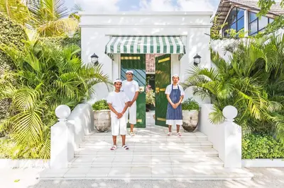 a group of three men standing in front of a white house at Pineapple Hill 4 Bed Luxury in Seminyak
