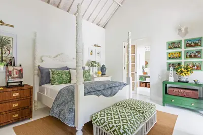 a bedroom with a bed and a ottoman in a room at Pineapple Hill 4 Bed Luxury in Seminyak