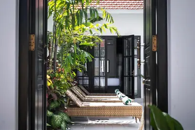 an open door to a courtyard with plants at Martini Beachside Villa 3 in Canggu