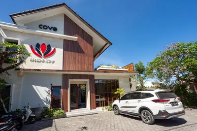 a white car parked in front of a building at Cove Ransha Stay in Sanur