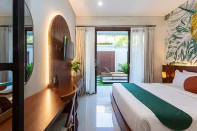 a hotel room with a bed and a desk and a bedroom at Cove Ransha Stay in Sanur