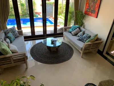 a living room with a couch and a coffee table at Villa Olga in Seminyak
