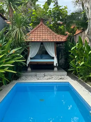 a gazebo next to a swimming pool at Villa Majegau 2 Seminyak in Seminyak
