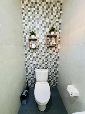 a bathroom with a white toilet in a room at Villa Majegau 2 Seminyak in Seminyak