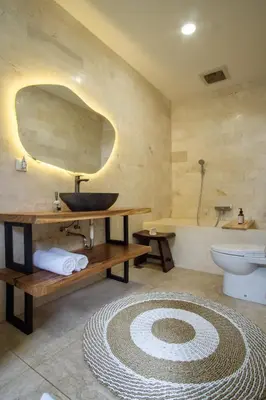 a bathroom with a sink and a toilet and a tub at Villa Maxima by Maheswara in Canggu