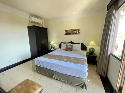 a bedroom with a large bed in a room at Beach Apartment inside Resort Walking Distance to the beach in Seminyak