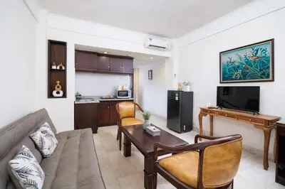 a living room with a couch and a table at Beach Apartment inside Resort Walking Distance to the beach in Seminyak