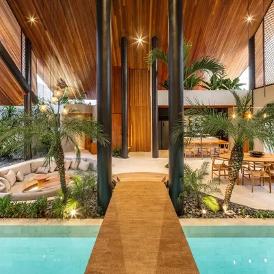 a resort with a pool and palm trees at Can Maestro Bali by House of Winds - Lush Sanctuary near Canggu in Kerobokan