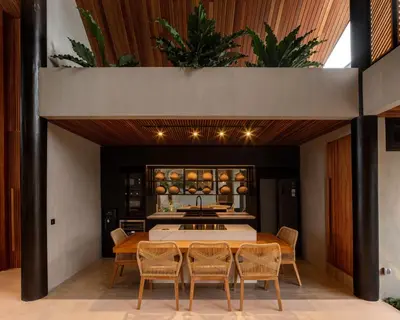 a kitchen and dining room with a table and chairs at Villa FEH Bali by House of Winds - Neo Tropical Eden near Canggu in Kerobokan