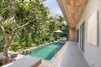 an infinity pool in the middle of a house with trees at Sin Nombre Bali - Sauna, Ice Bath & Roof Terrace in Canggu