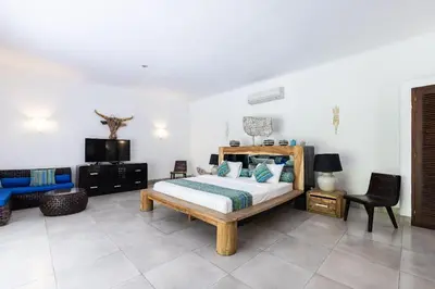 a bedroom with a bed and a tv in it at Villa Permata Umalas - Relaxing Tropical Oasis in Seminyak