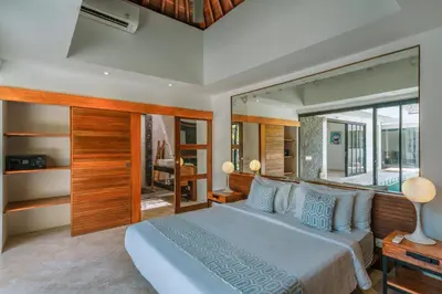 a bedroom with a large bed and a large window at Villa Kalila: Elegant 2 BR Villa in Perfect Location ! in Seminyak