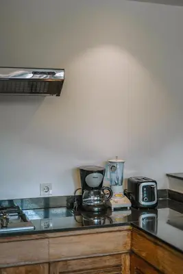 a kitchen counter with a stove and appliances on it at Villa Kalila: Elegant 2 BR Villa in Perfect Location ! in Seminyak