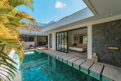 an infinity pool in a villa with a bedroom at Villa Kalila: Elegant 2 BR Villa in Perfect Location ! in Seminyak
