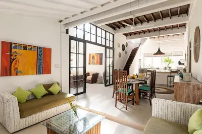 a living room with a couch and a dining room at Villa Nyama by Optimum Bali Villas in Seminyak