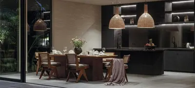 a dining room with a table and a kitchen at Black Villas Canggu Beach by OXO in Canggu