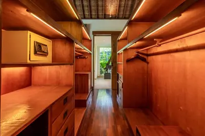 a kitchen with wooden cabinets and a wooden floor at Villa Ku Besar by Villa Finder in Dalung